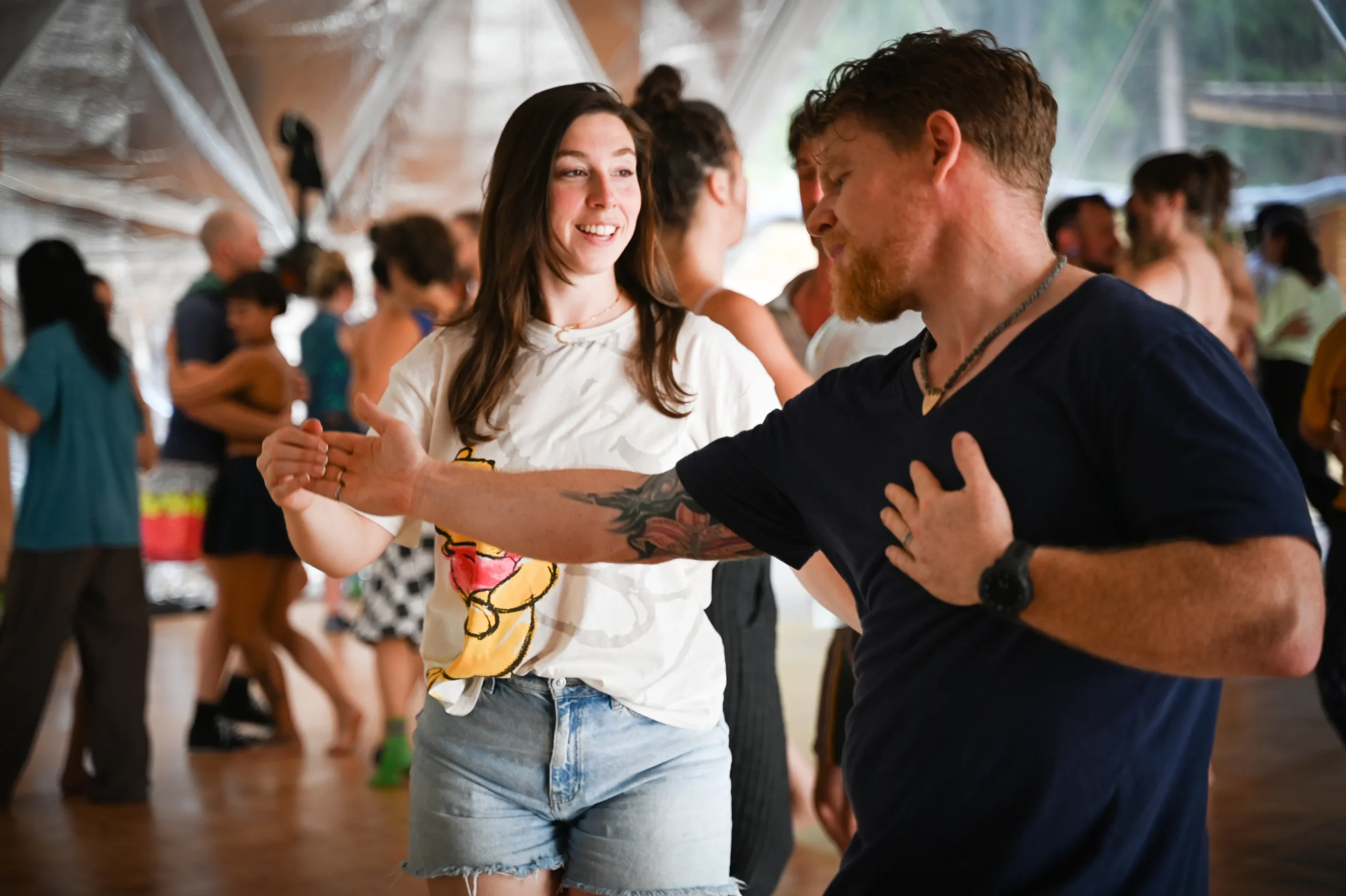 Two dancers practicing together at a dance class.